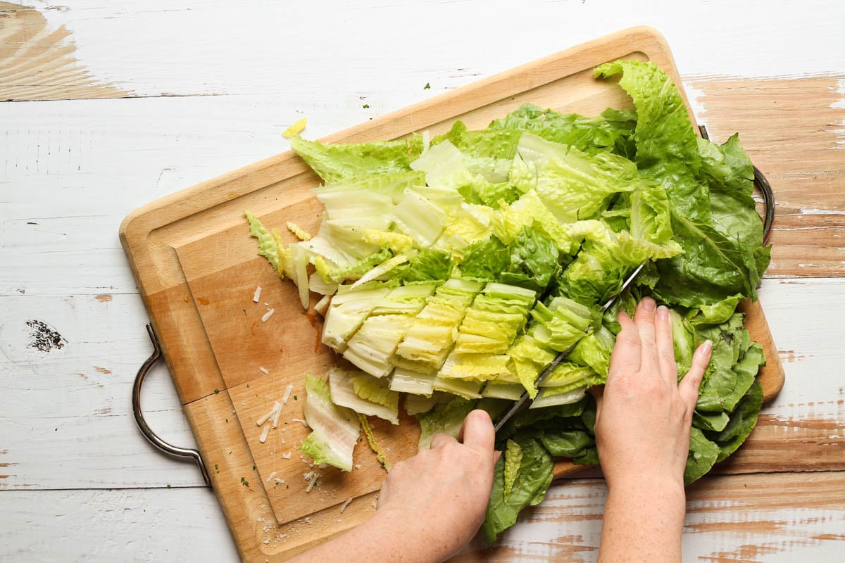 Chopping romaine lettuce on a cutting board