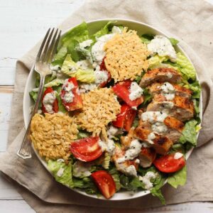 healthy chicken caesar salad in a shallow bowl