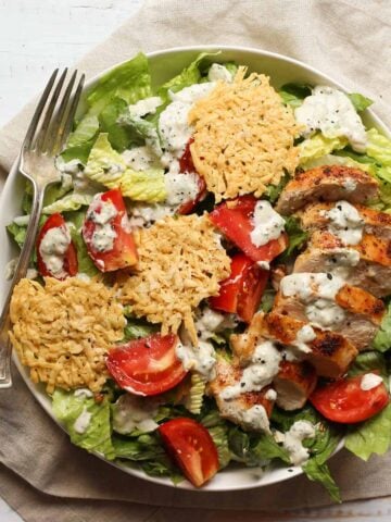 healthy chicken caesar salad in a shallow bowl
