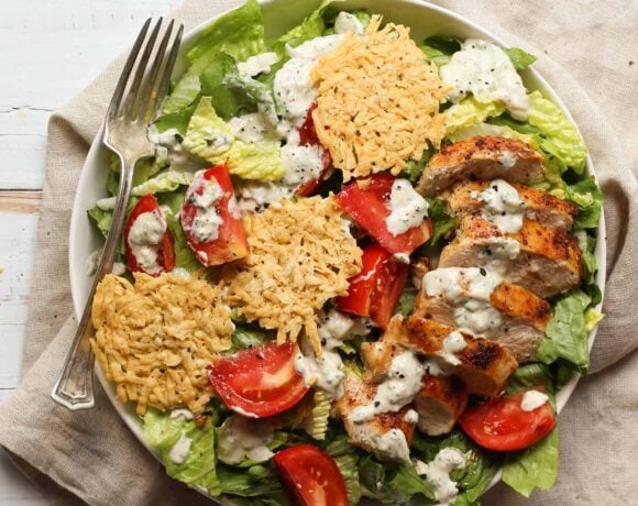 healthy chicken caesar salad in a shallow bowl