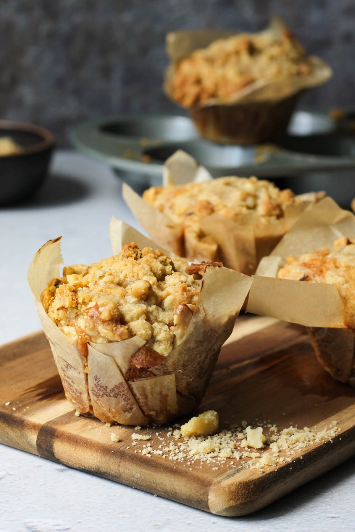 Banana muffins with streusel topping on a cutting board