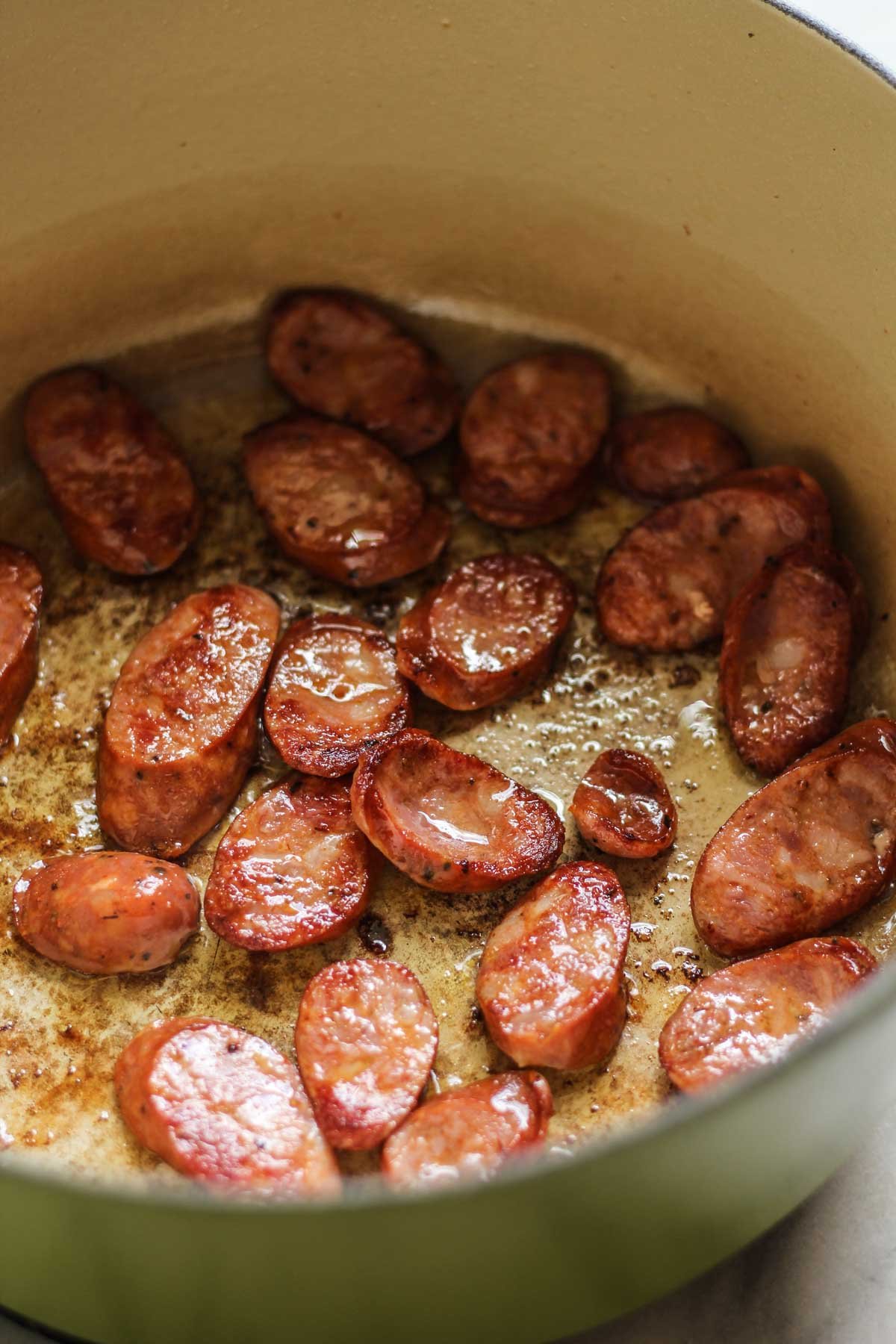 Sliced Cajun Sausage sauteeing in a pot