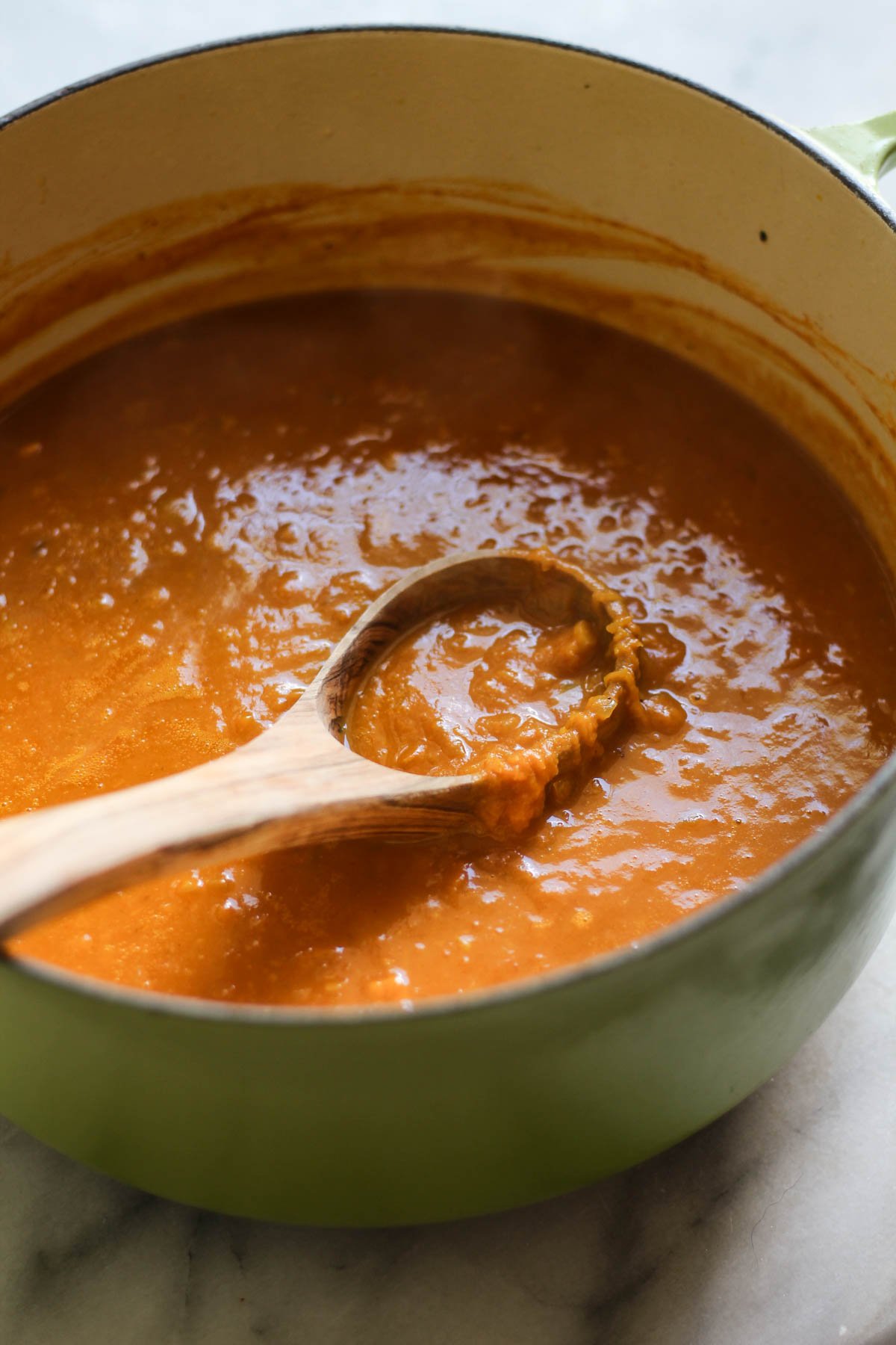 Pumpkin butternut squash soup in a pot with a ladle