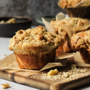 Banana muffins with a streusel topping on a cutting board