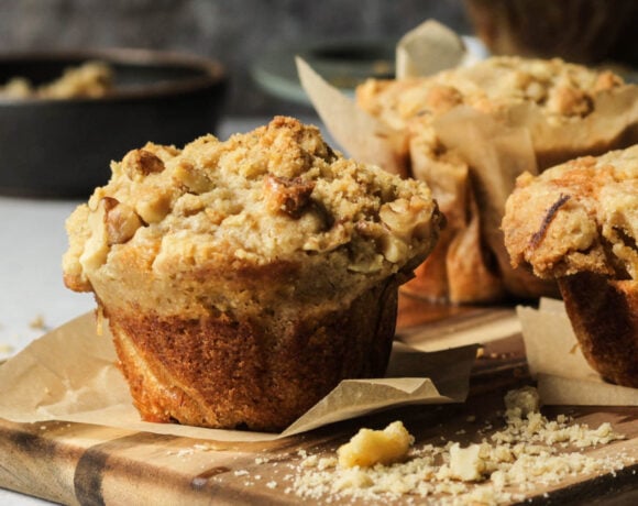 Banana muffins with a streusel topping on a cutting board