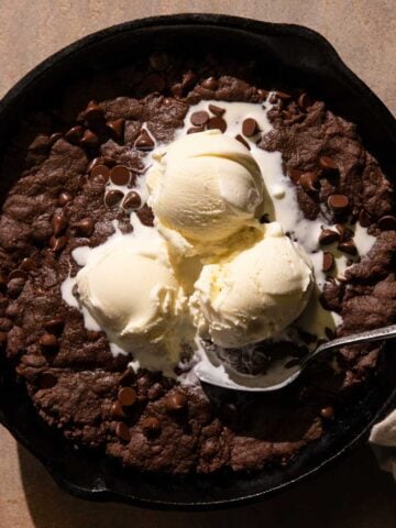 Double Chocolate Skillet Cookie with ice cream and a spoon