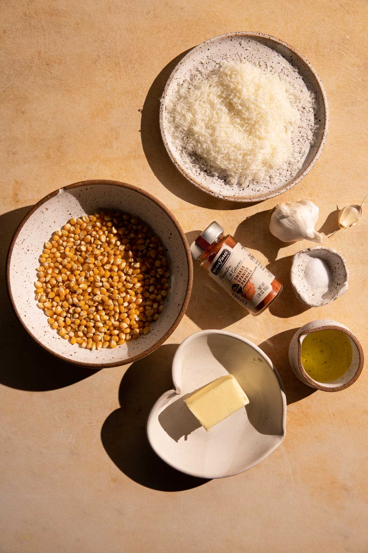 Ingredients in bowls and plates for garlic parmesan popcorn