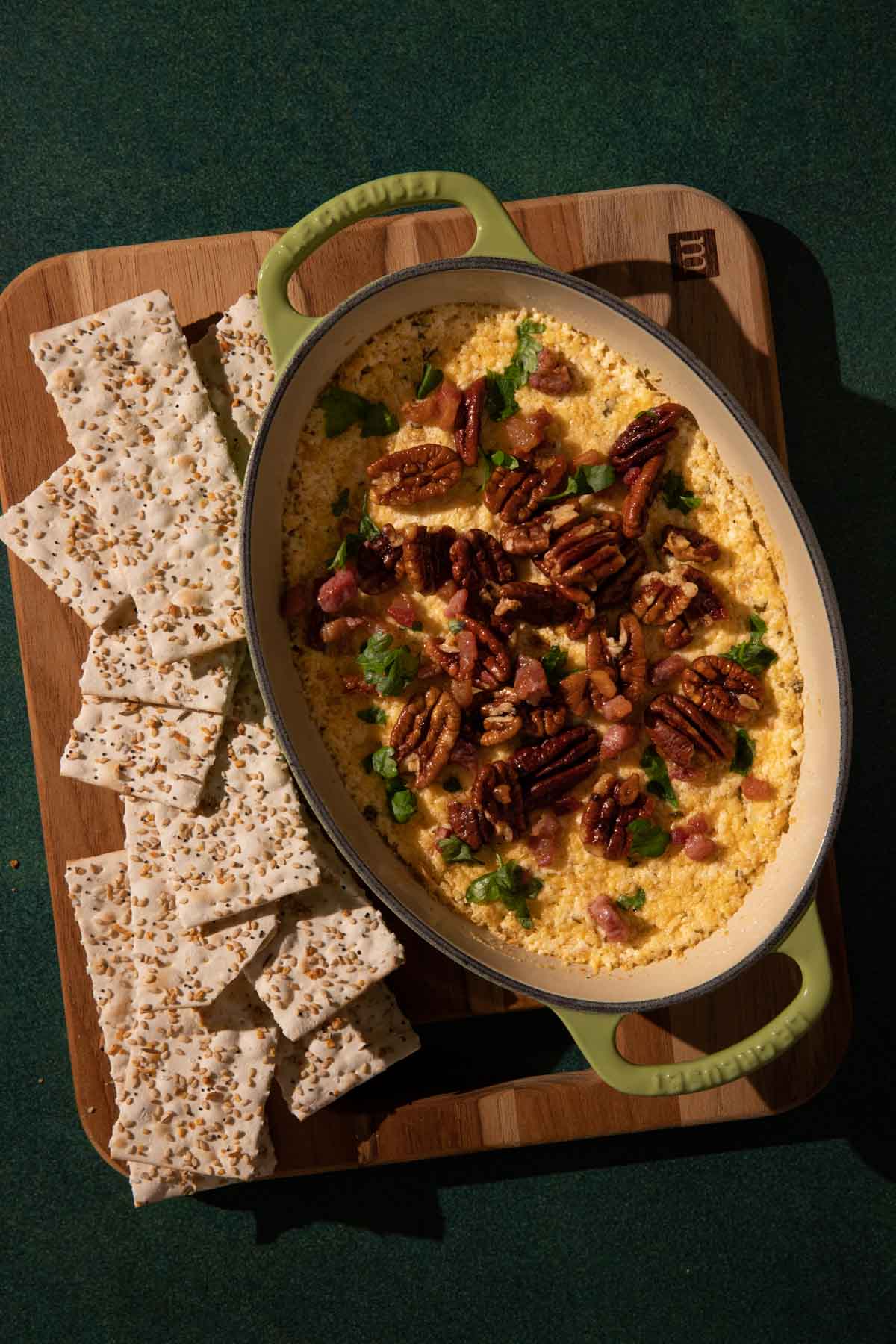 Goat Cheese dip in a ceramic pan topped with pecans 