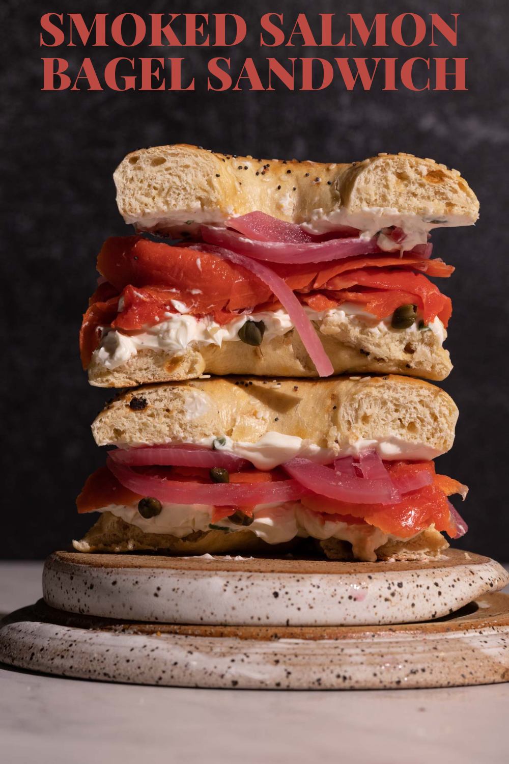 A smoked salmon bagel cut in half and stacked via @bessiebakes