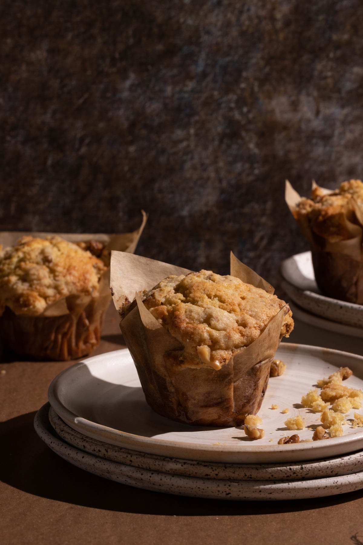 A Banana walnut muffin on stacked plates