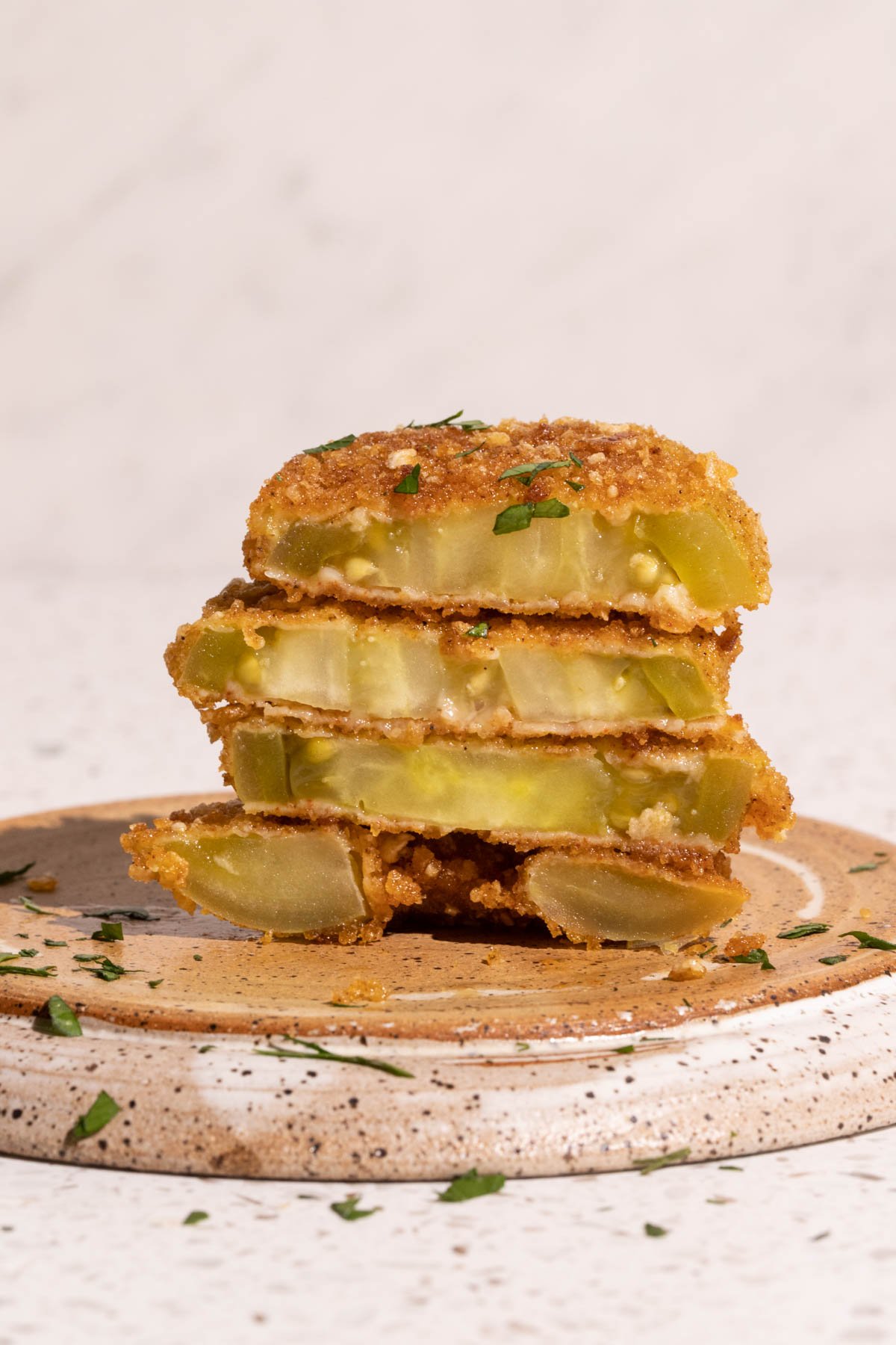 A stack of fried green tomatoes sliced in half