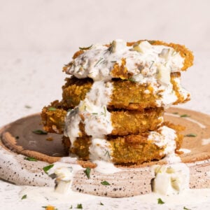 Fried green tomatoes with dill pickle ranch dip drizzled on top