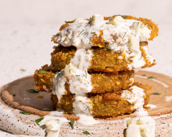 Fried green tomatoes with dill pickle ranch dip drizzled on top