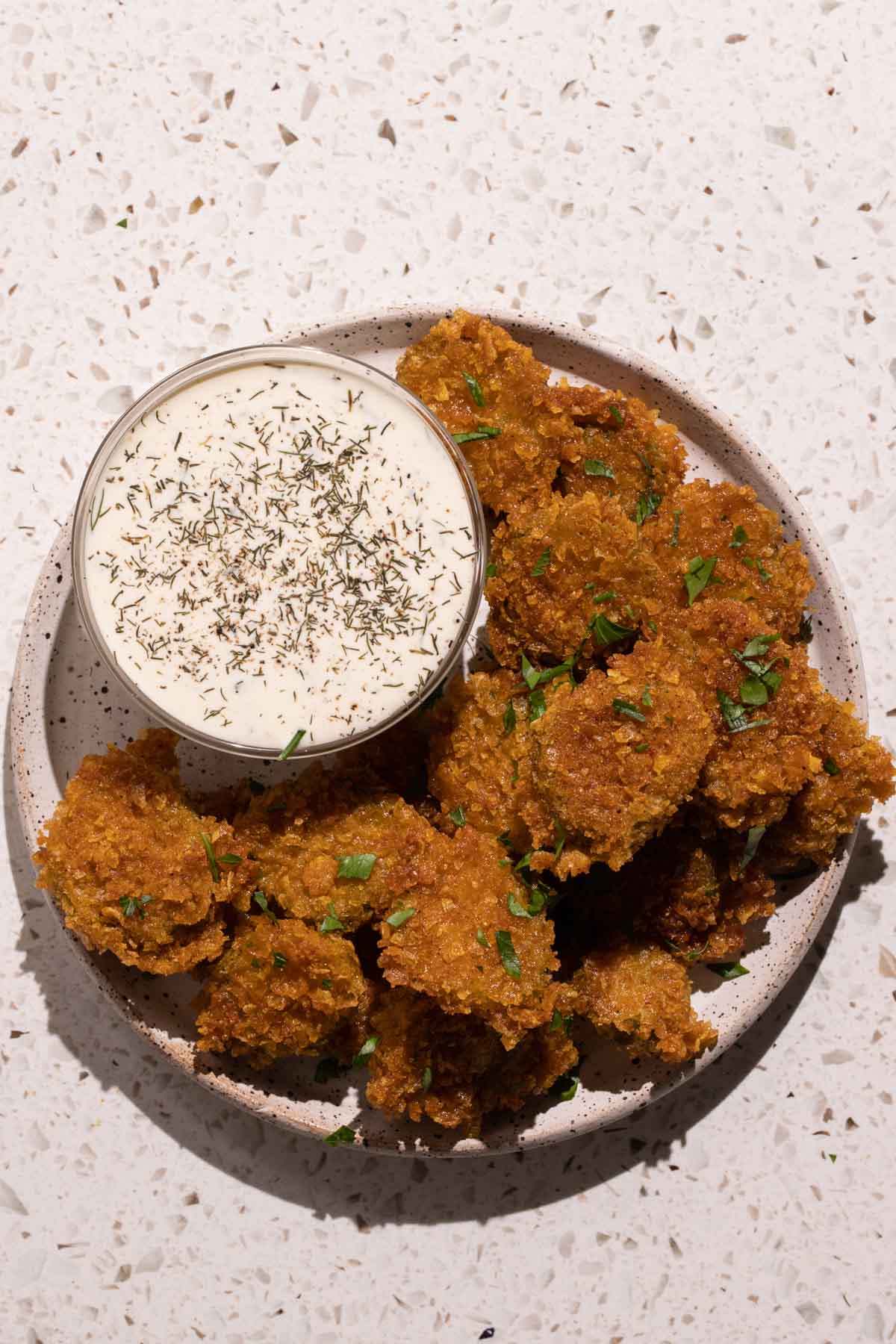 A plate with Fried pickles and dill pickle ranch dressing