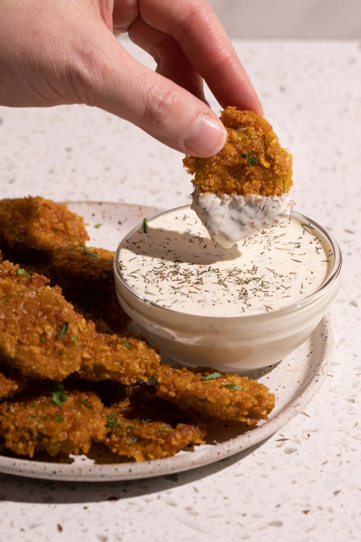 Fried pickles dipped in a dill pickle ranch dressing