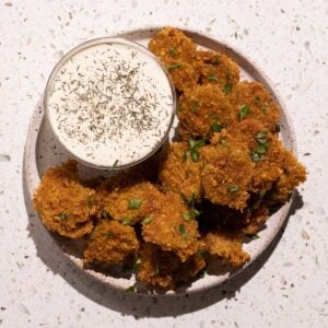 A plate of fried pickles with dill pickle ranch dressing