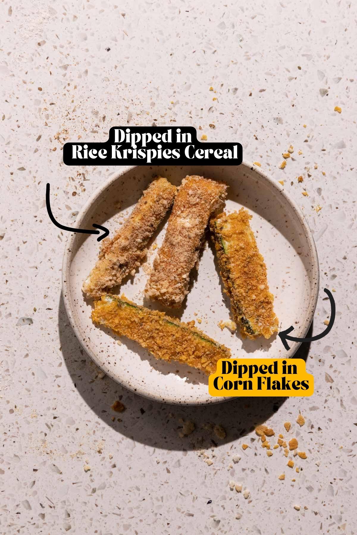 Zucchini Sticks dredged in rice krispies and corn flakes on a plate
