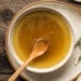 chicken stock in a bowl with fresh thyme